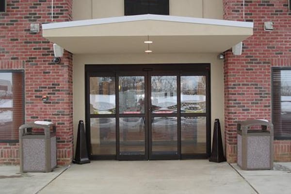 Automatic bi-part sliding doors brick building