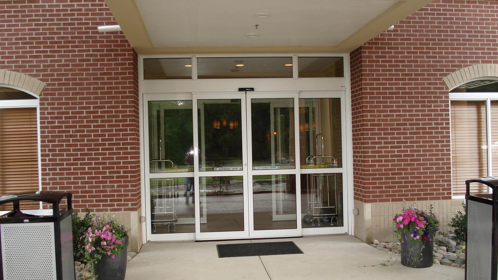 Automatic doors brick building with flower planters